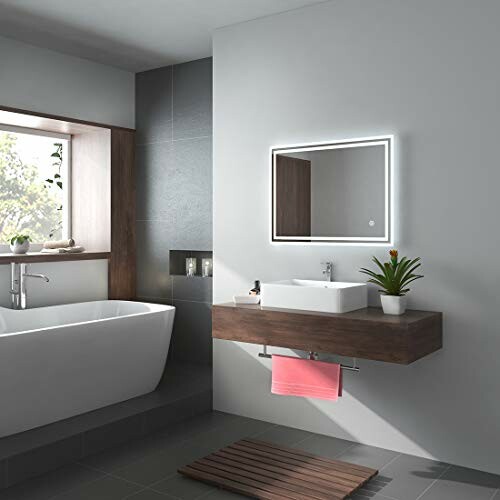 Salle de bain moderne avec baignoire et lavabo.